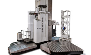 Gruppo Parpas ML 120. A large floor borer featuring a vertical column with a spindle head for precision machining a large horizontal worktable for holding workpieces. It also includes an automatic tool changer system on the right side, enclosed components, and a metal platform with safety railings. Sold in the U.K by Leader CNC Technologies