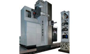 Gruppo Parpas ML 200. A large floor borer featuring a vertical column with a spindle head for precision machining a large horizontal worktable for holding workpieces. It also includes an automatic tool changer system on the right side, enclosed components, and a metal platform with safety railings. With an enclosure for control of the machine. Sold in the U.K by Leader CNC Technologies