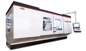 THS100 Gruppo Parpas cnc machine with enclosed design, large sliding doors and a mounted control panel. Leader CNC Technologies