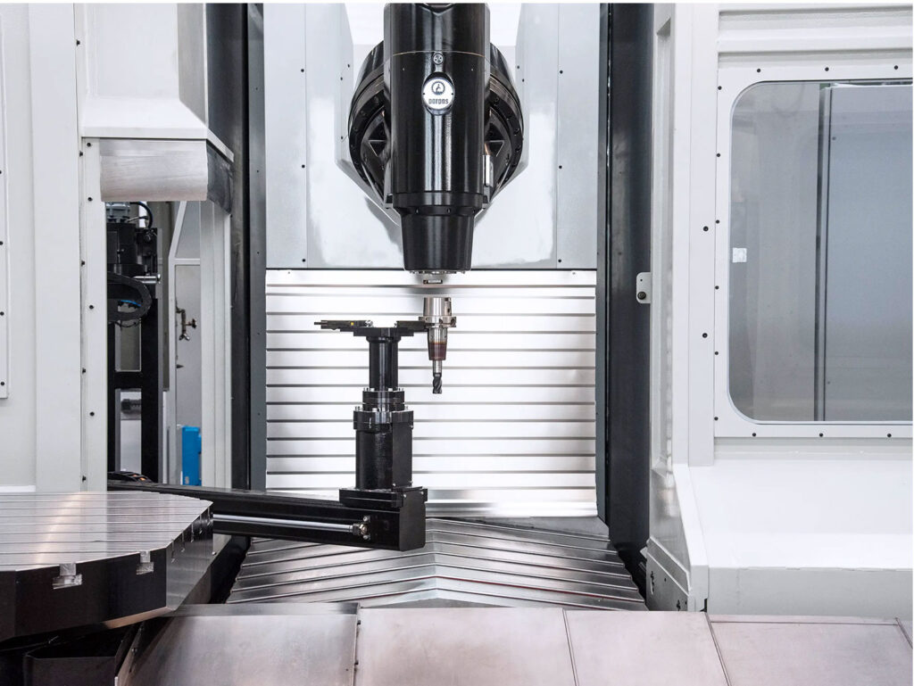 Front view of the tool being changed and being placed in to the spindle head on the Gruppo Parpas THS100 CNC machine with doors open, sold in the U.K. by Leader CNC Technologies.