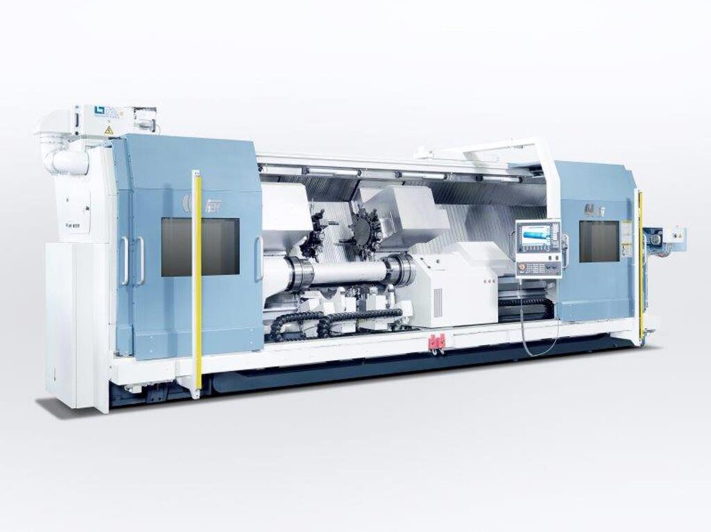 A side view of a large FCT FAT Haco lathe with doors open, sold by Leader CNC Technologies.