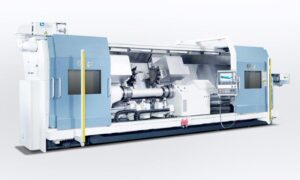A side view of a large FCT FAT Haco lathe with doors open, sold by Leader CNC Technologies.