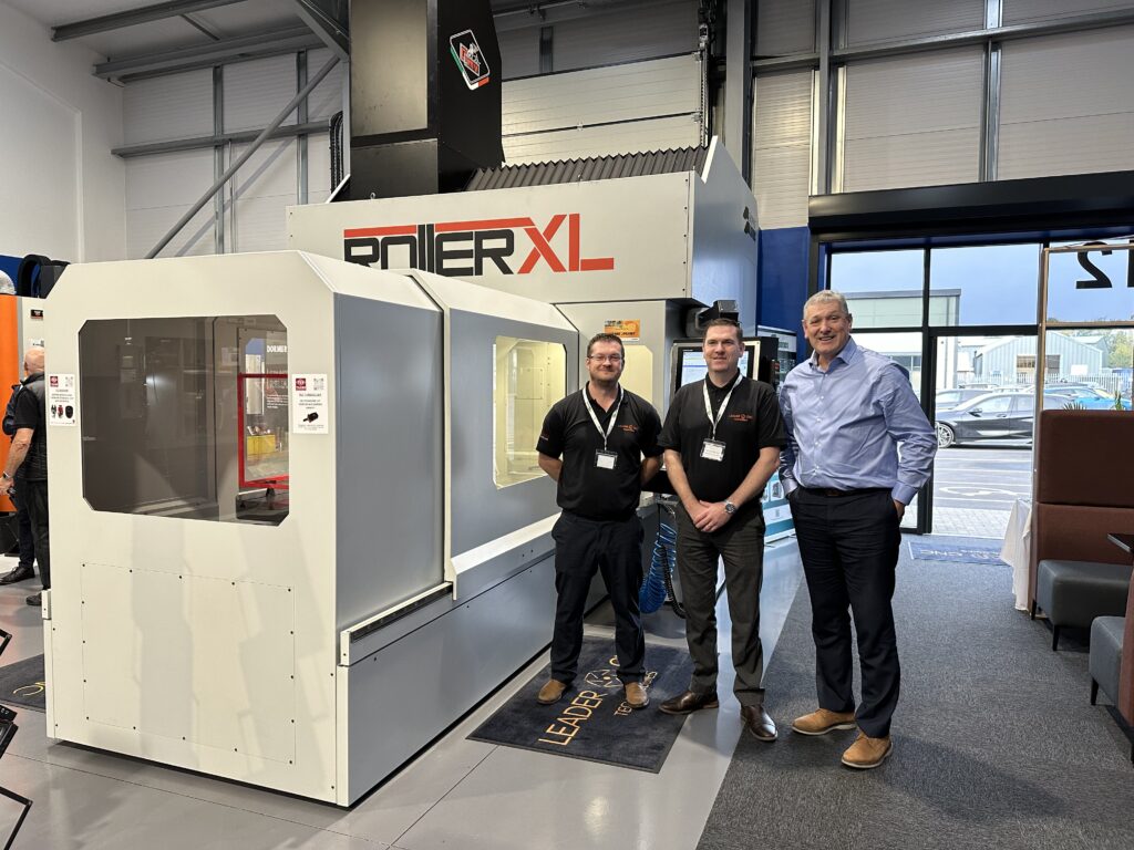 Leader CNC Technologies showroom with team members standing next to Gruppo Parpas Roller XL