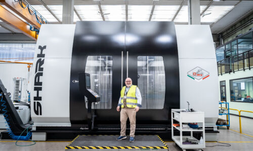 Sales Director at Leader CNC Technologies standing next to the SHARK GRUPPO PARPAS 5-AXIS Milling Machine